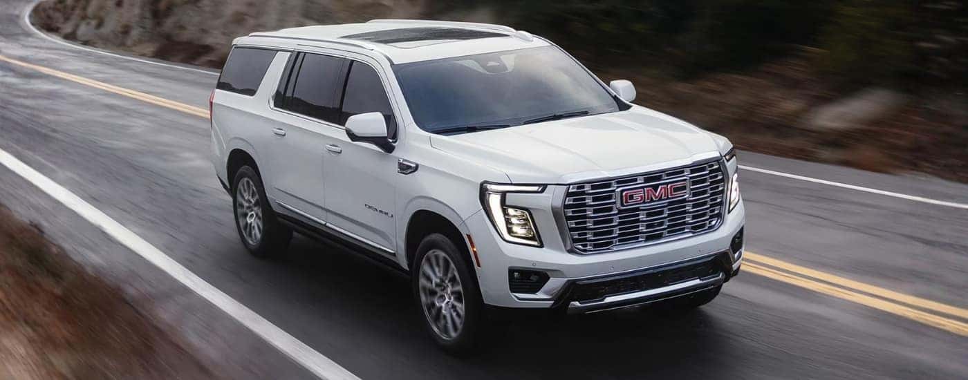 White 2026 GMC Yukon Denali driving to a GMC dealer near Lexington