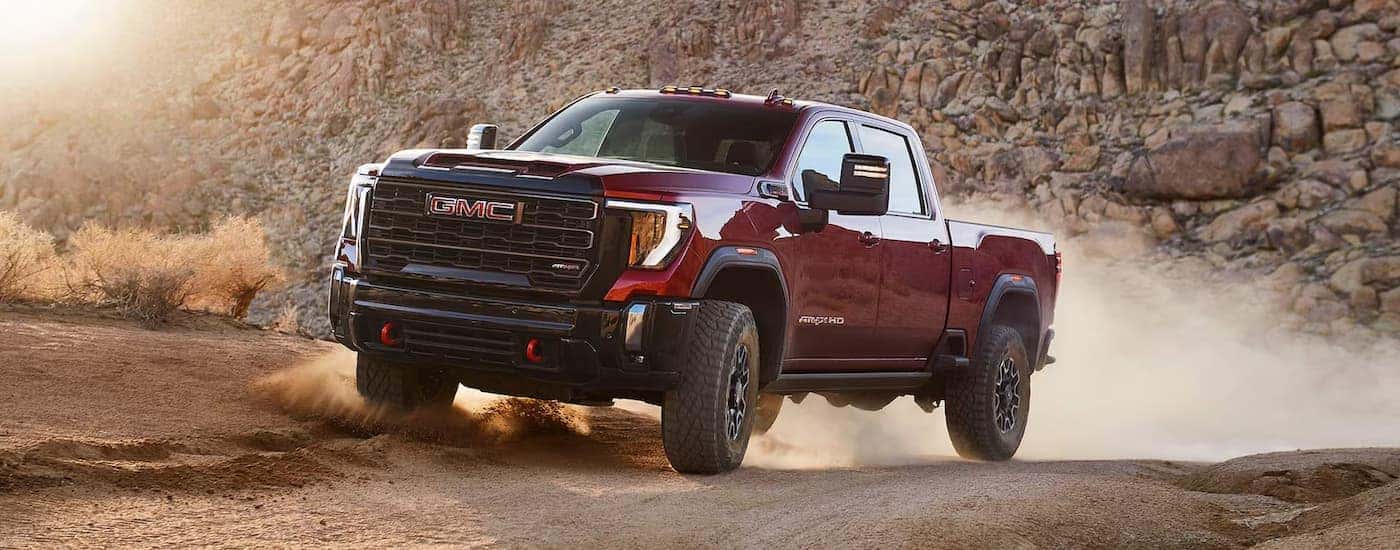 A red 2025 GMC Sierra 2500 HD AT4 off-roading from a dealer near Clemmons