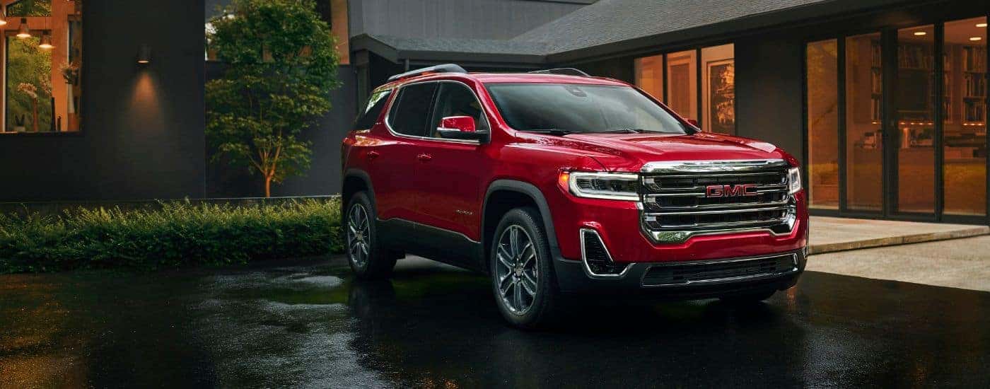 A red used 2023 GMC Acadia for sale near Lexington parked in a driveway