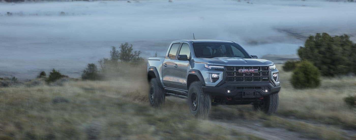 A grey 2025 GMC Canyon from the front at an angle.