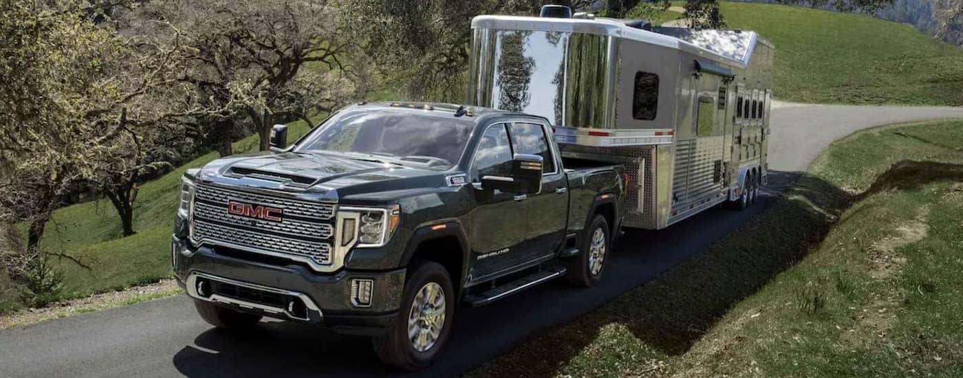 Grey 2023 GMC Sierra 2500 towing a horse trailer