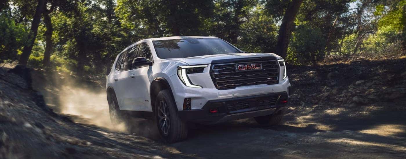 A white 2026 GMC Acadia from the front at an angle.