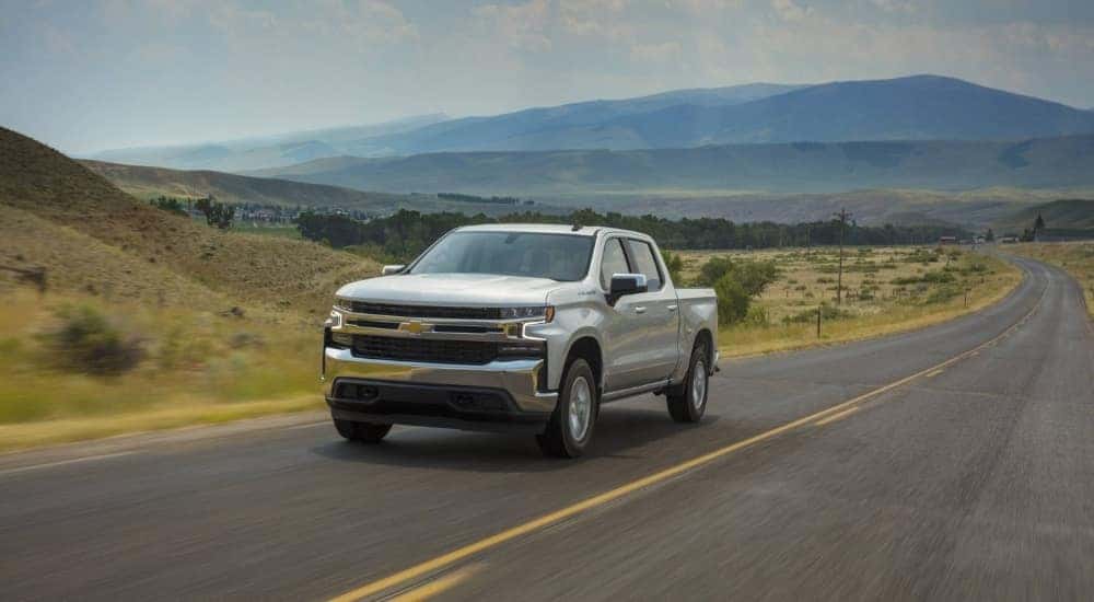 Silver 2021 Chevy Silverado 1500 LT driving on a highway