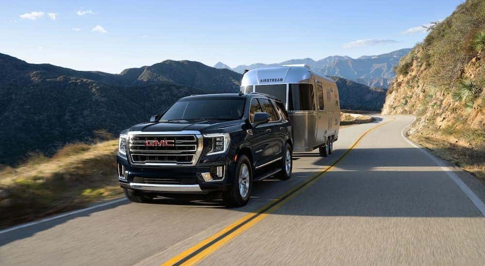 Black 2021 GMC Yukon towing an Airstream trailer