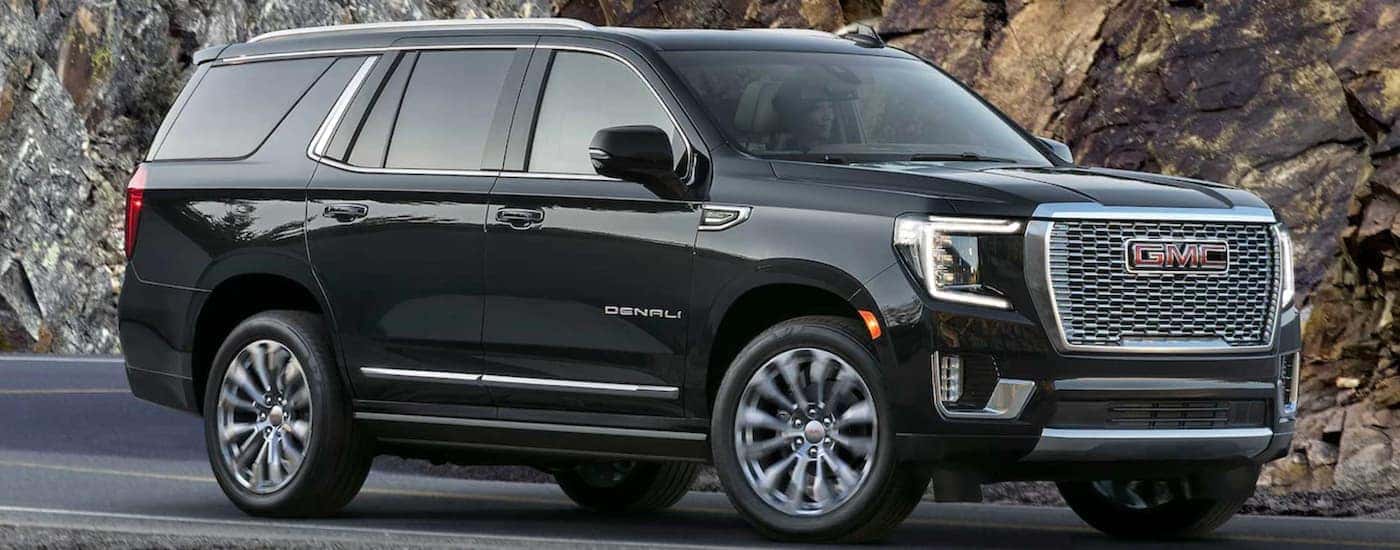 Black 2023 GMC Yukon Denali driving on an open road
