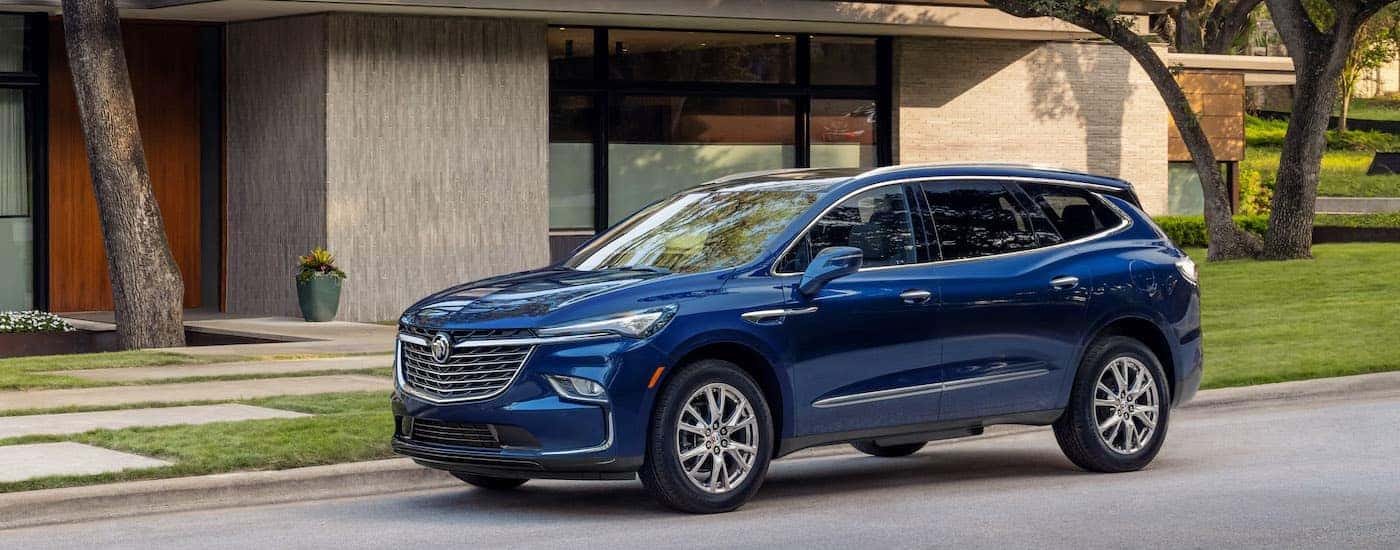 A blue 2023 Buick Enclave is shown from the side.