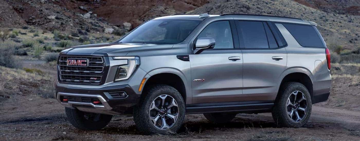 A silver 2025 GMC Yukon AT4 is shown parked after visiting a GMC dealer in Greenville.