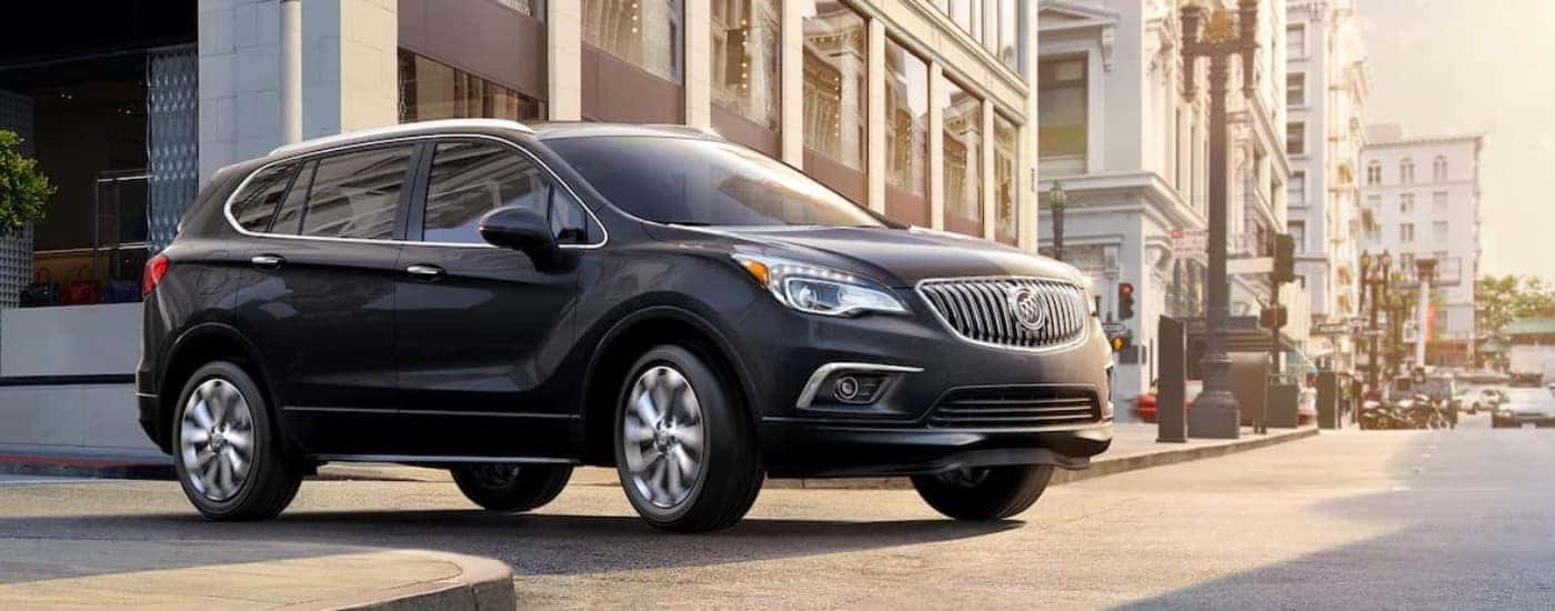 A black 2018 Buick Envision is shown driving to a Buick dealer.