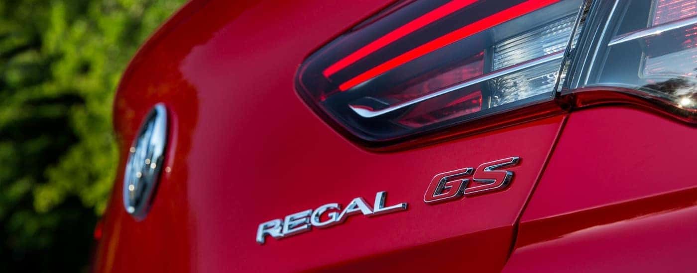 A close-up shows the rear badging on a red 2018 Buick Regal GS.