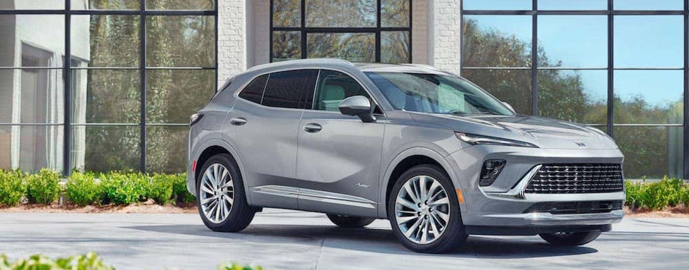 A silver 2024 Buick Envision Avenir is shown from the side.