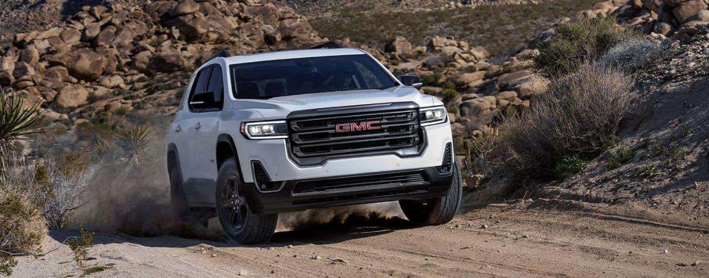 A white 2022 GMC Acadia driving to a used GMC dealer near Easley.