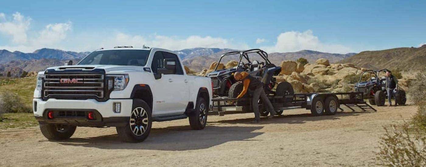 A white 2020 GMC Sierra 2500 AT4 is shown from the front at an angle.