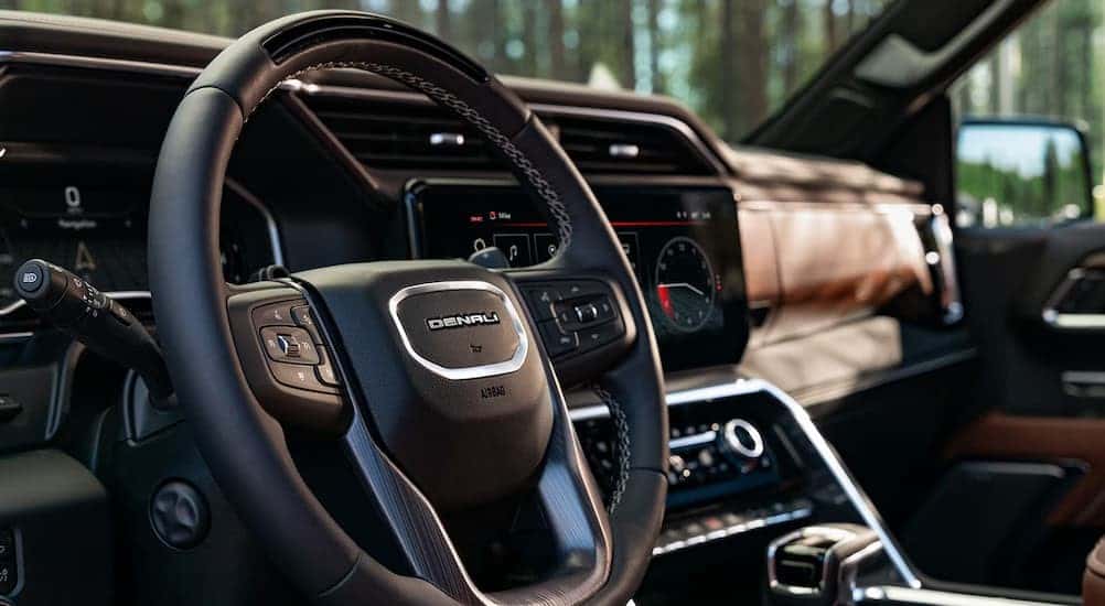 A close-up of the steering wheel and dash in a 2025 GMC Sierra 1500 Denali.
