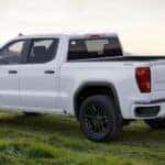 A white 2025 GMC Sierra 1500 for sale is shown parked on grass.