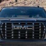 A close-up of the front-end is shown on a black 2025 GMC Yukon for sale.