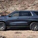 A blue 2025 GMC Yukon XL Denali is shown parked off-road after viewing a GMC Yukon for sale.