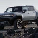 A grey 2025 GMC Hummer EV for sale is off-roading.