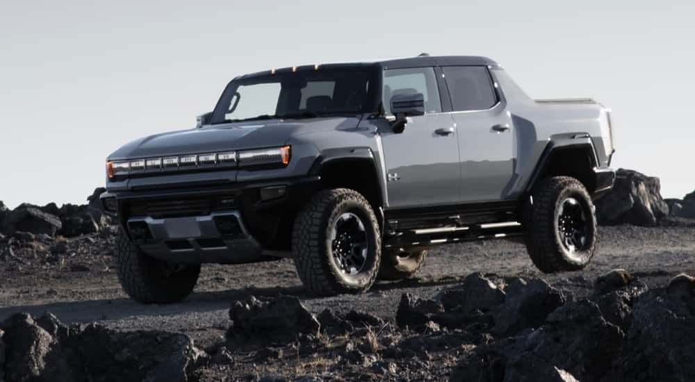 A grey 2025 GMC Hummer EV for sale is off-roading.