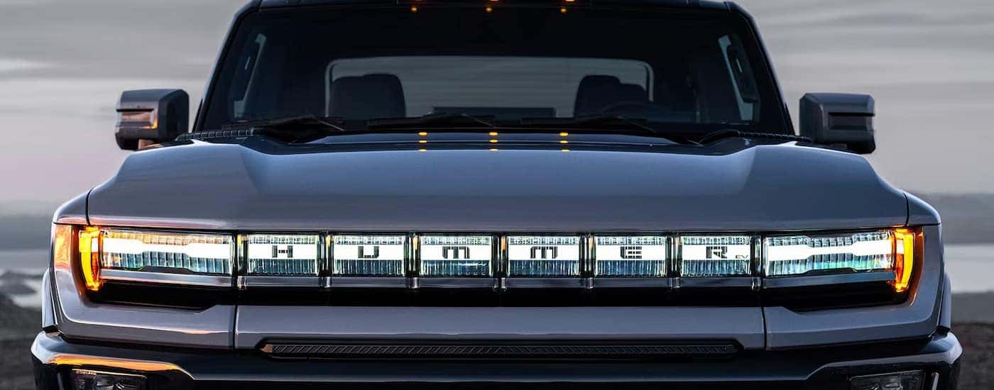 The grille and headlights on a grey 2025 GMC Hummer EV Pickup for sale.
