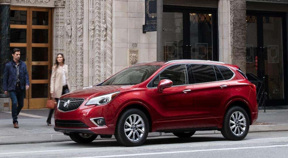A red 2020 Buick Envision parked on a city street.
