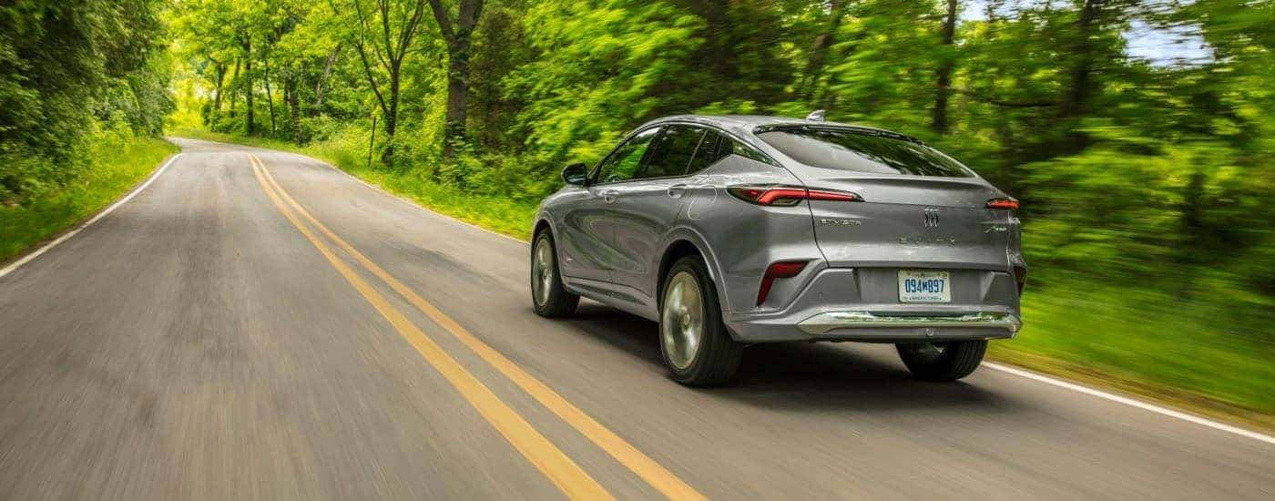 A silver 2024 Buick Envista Avenir is shown from the rear at an angle after leaving a Buick dealer near Spartanburg.