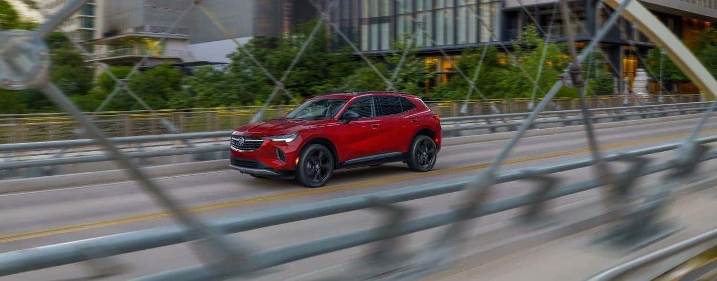 A red 2024 Buick Envision is shown from the side after leaving a Buick dealer near Taylors.