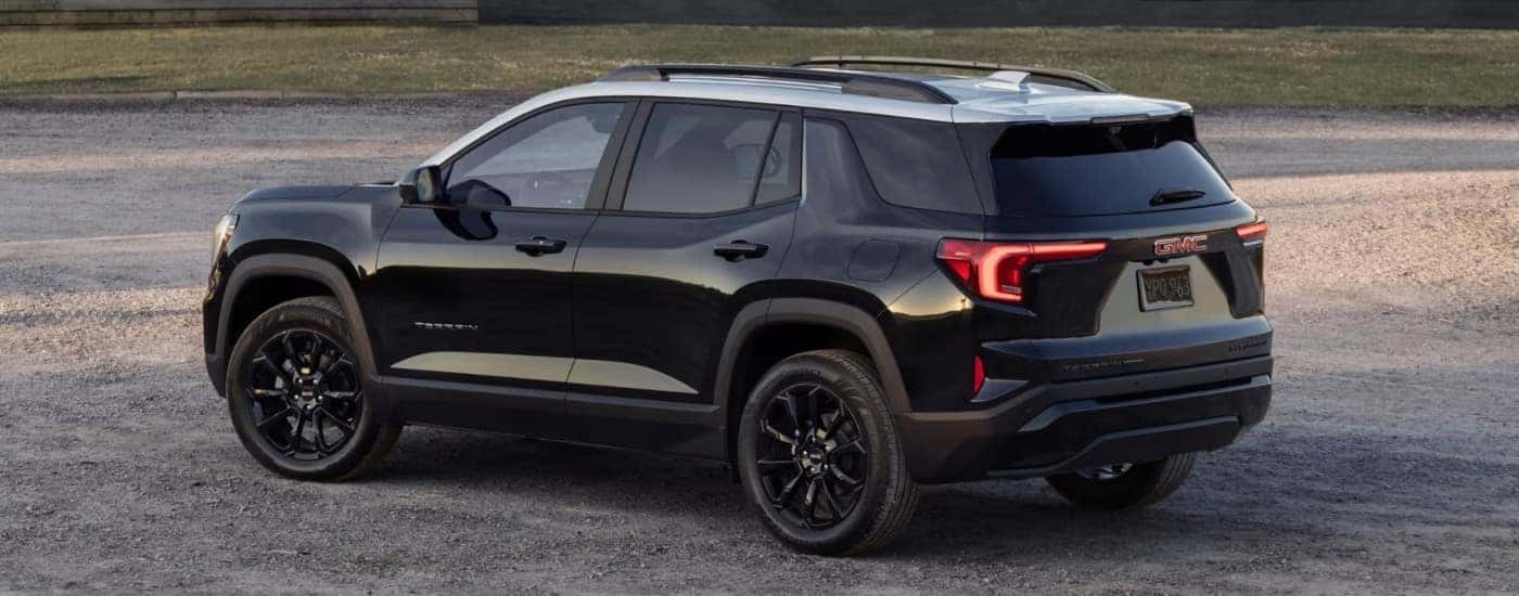 A black 2025 GMC Terrain is shown parked after visiting a GMC dealer.
