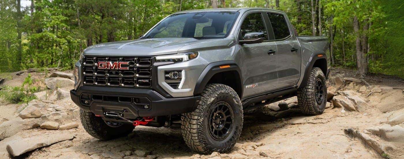 A grey 2025 GMC Canyon AT4X AEV parked in the woods after leaving a GMC dealer near Taylors.