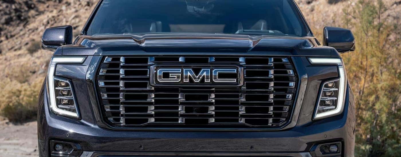 A close-up on the front of a black 2025 GMC Yukon.
