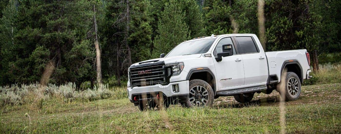 A white 2020 GMC Sierra 2500 HD AT4 parked off-road.
