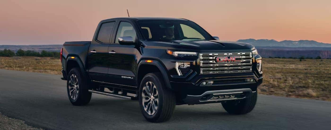 A black 2024 GMC Canyon is shown parked after viewing a used GMC dealer near Taylors.