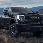 Black 2025 GMC Sierra HD parked off-road.