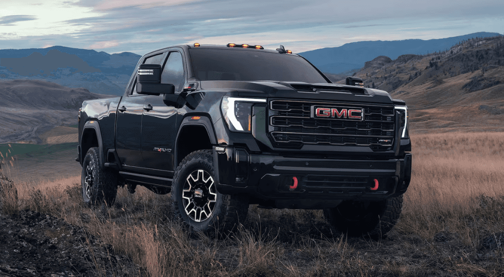Black 2025 GMC Sierra HD parked off-road.