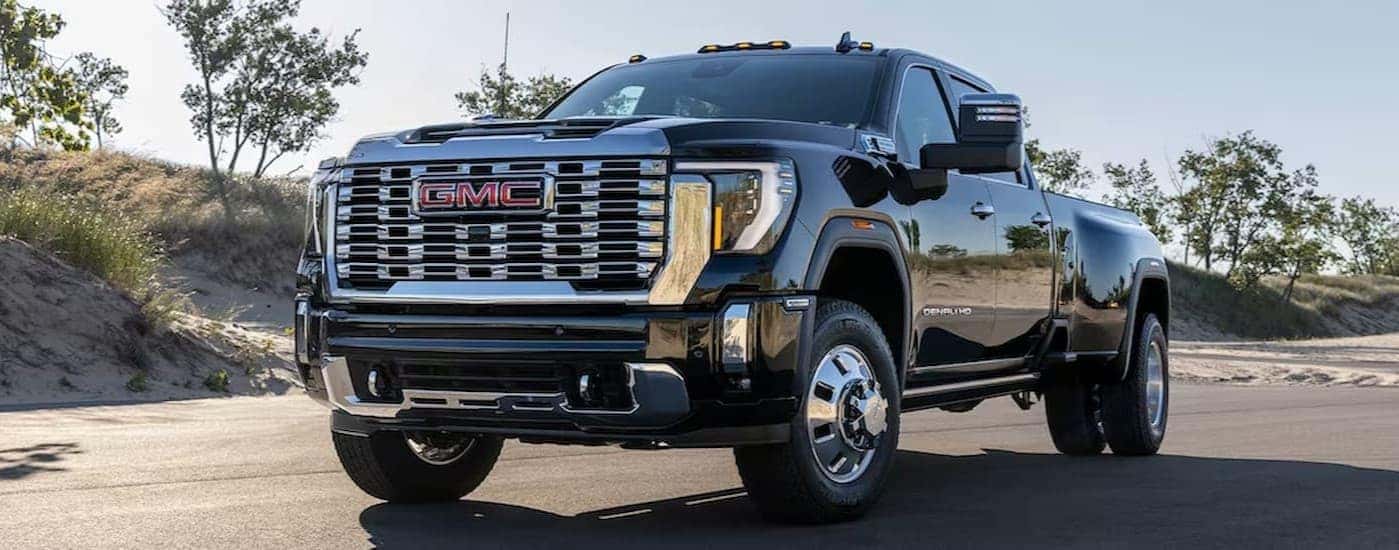 A black 2025 GMC Sierra 2500 for sale near me parked off-road.
