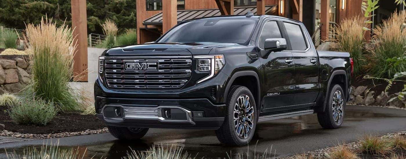 A black 2026 GMC Sierra 1500 parked on a driveway.