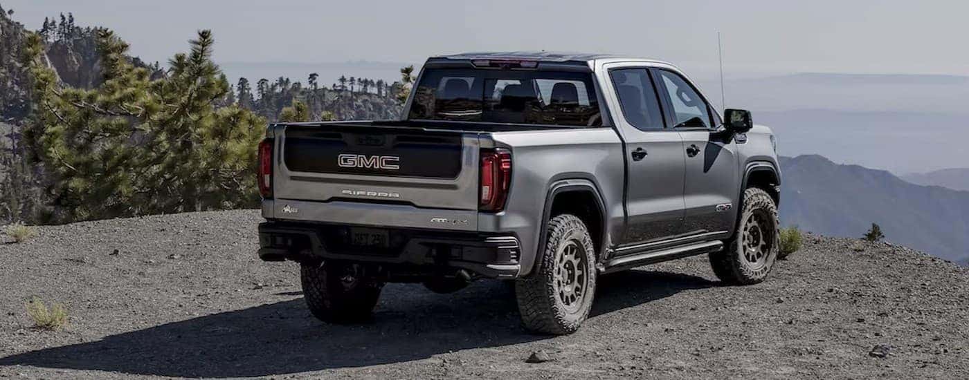 A silver 2025 GMC Sierra 1500 AT4X parked off-road.
