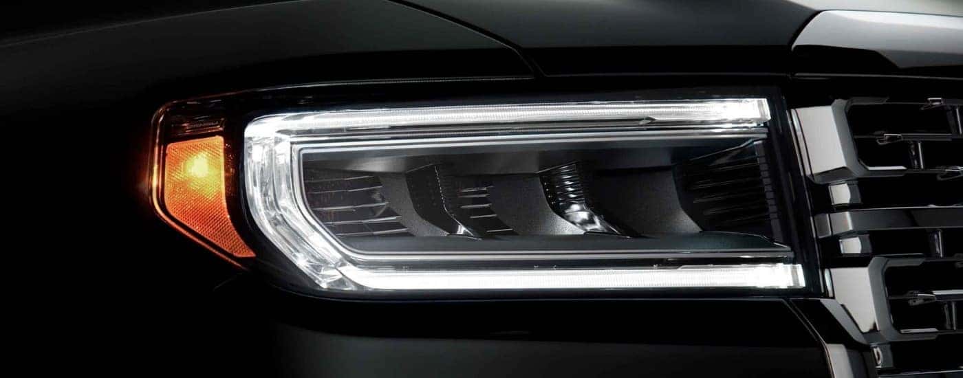 Passenger side headlight on a black 2023 GMC Acadia Denali