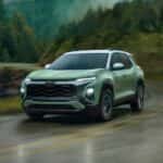 A green 2025 Chevy Equinox ACTIV driving in the rain.