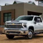 A white 2023 Chevy Silverado 2500 parked on a construction site.