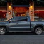 A gray 2019 GMC Sierra Denali parked near a restaurant.
