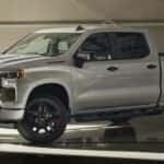A white 2024 Chevy Silverado 1500 RST redline Edition parked in a hangar.