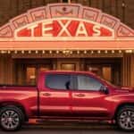 A red used 2023 Chevy Silverado 1500 RST parked outside a building in Texas