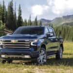 A blue 2022 Chevy Silverado High Country is shown from the front at an angle after leaving a dealer that has Chevy trucks for sale near Spring, TX.