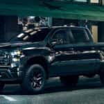 A black 2023 Chevy Silverado 1500 Z71 Trail Boss is shown from the side.