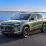 A green 2024 Chevy Trax Activ is shown from the front at an angle after leaving a dealer that has a Chevy Trax for sale.