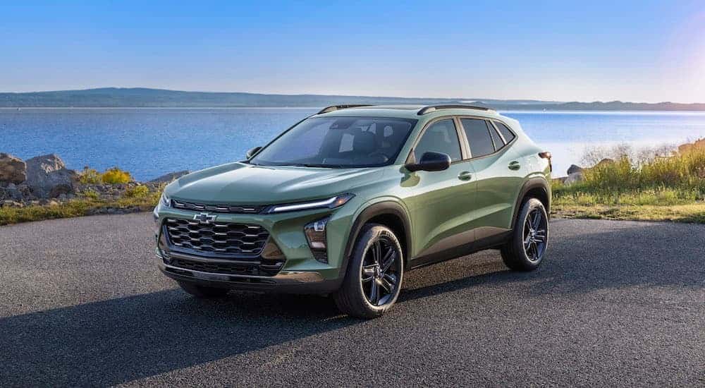 A green 2024 Chevy Trax Activ is shown from the front at an angle after leaving a dealer that has a Chevy Trax for sale.