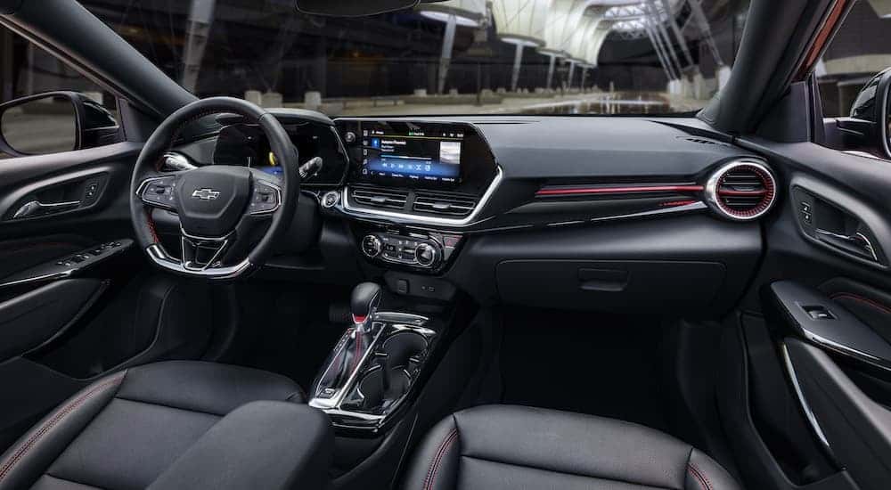 The black interior of a 2024 Chevy Trax RS is shown from the passenger seat.