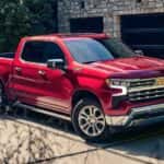 A red 2024 Chevy Silverado 1500 LTZ parked in a driveway.