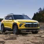 A yellow 2024 Chevy Trailblazer ACTIV parked off-road on a shore.