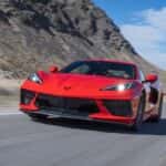 Red 2020 Chevy Corvette Stingray driving to look at used cars for sale near Katy